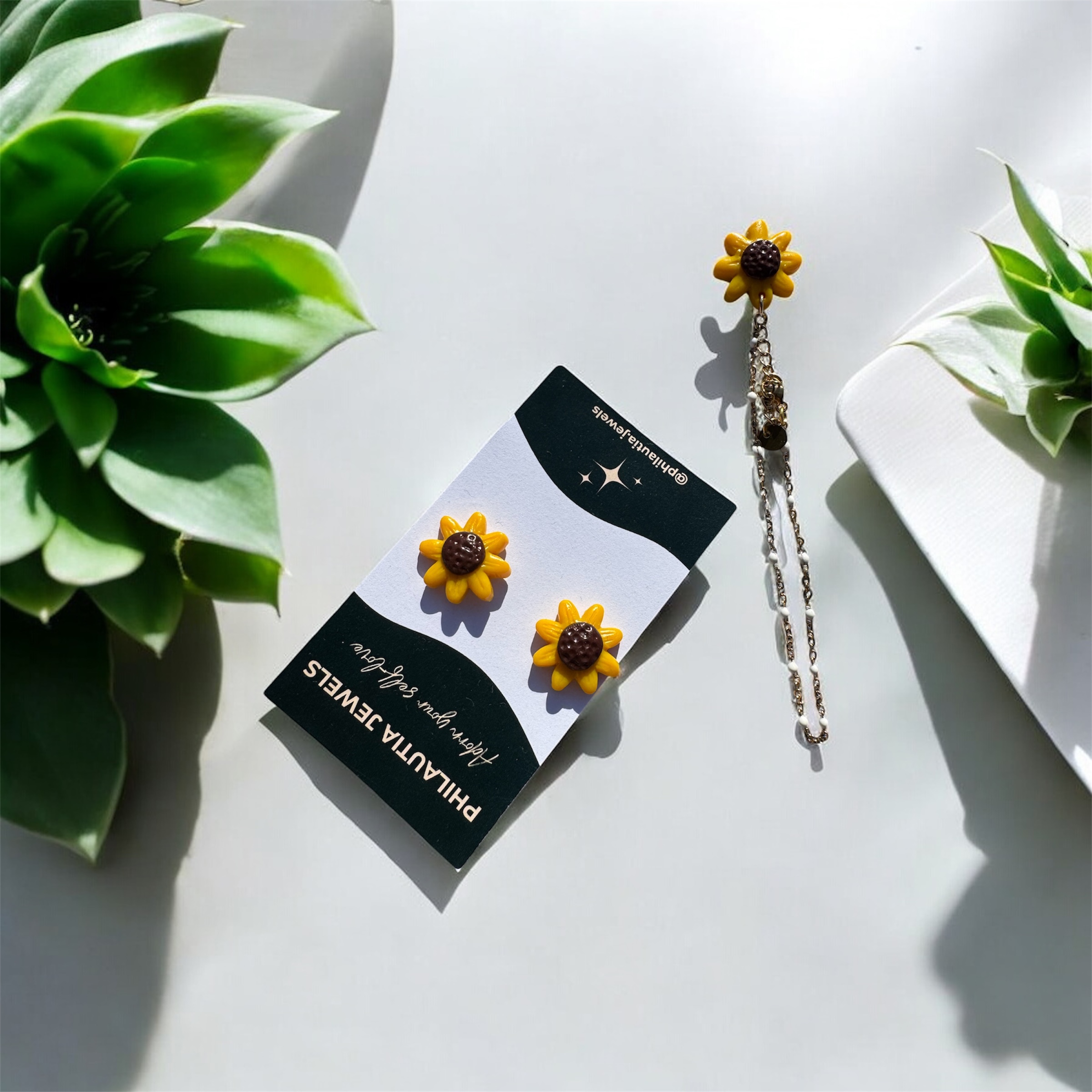 Sunflower stud earrings on a Philautia Jewels card