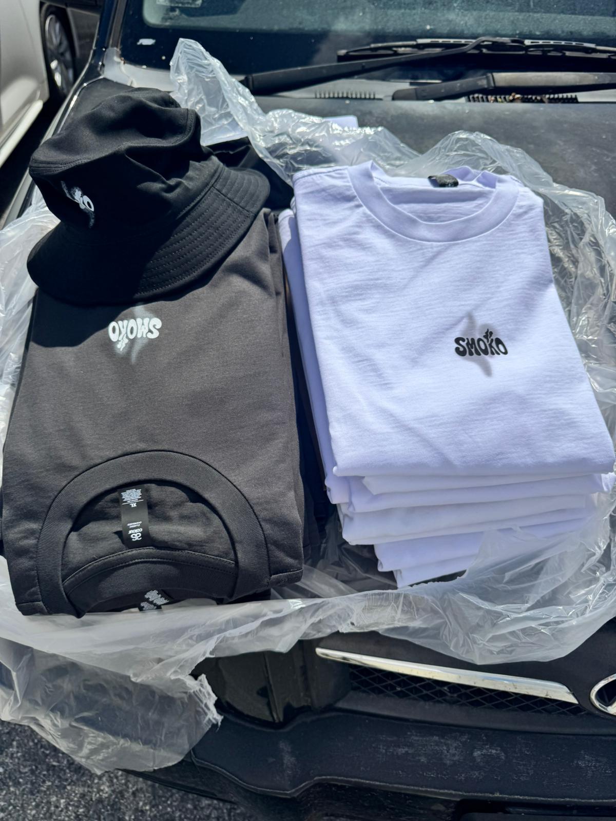 Folded SMOKO t-shirts and bucket hat with embroidered logo